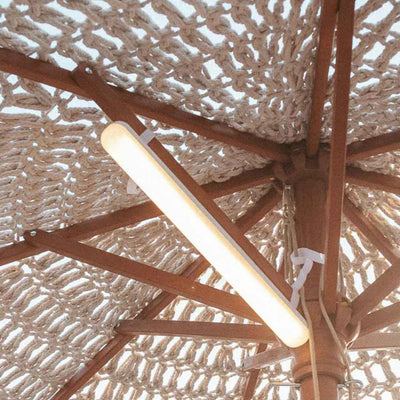 Banana cordless lamp by Newgarden with magnetic mount, offering RGB and warm light for patio umbrellas.