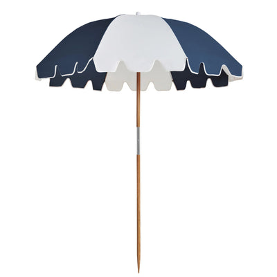 The Weekend Umbrella in Steel by Basil Bangs providing stylish beach shade.