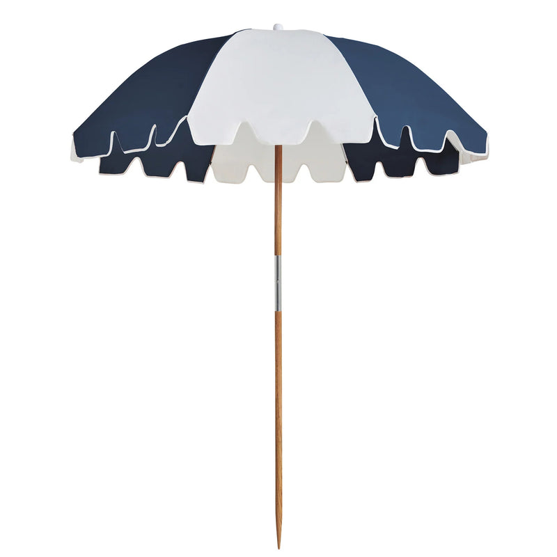 The Weekend Umbrella in Steel by Basil Bangs providing stylish beach shade.